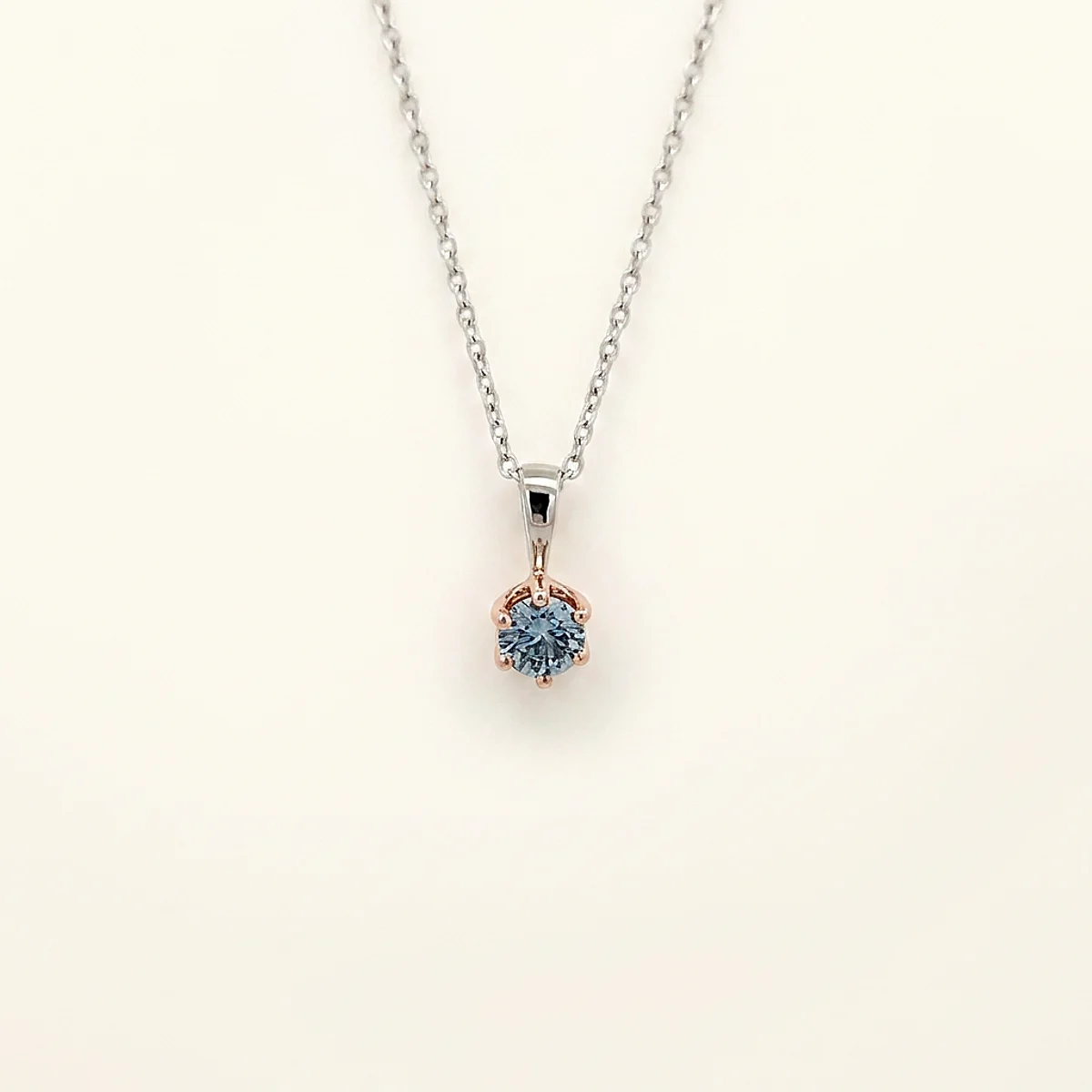 A .25ct blue round diamond on a mixed metal pendant, custom-designed by Eterneva to honor the remarkable Rocky.