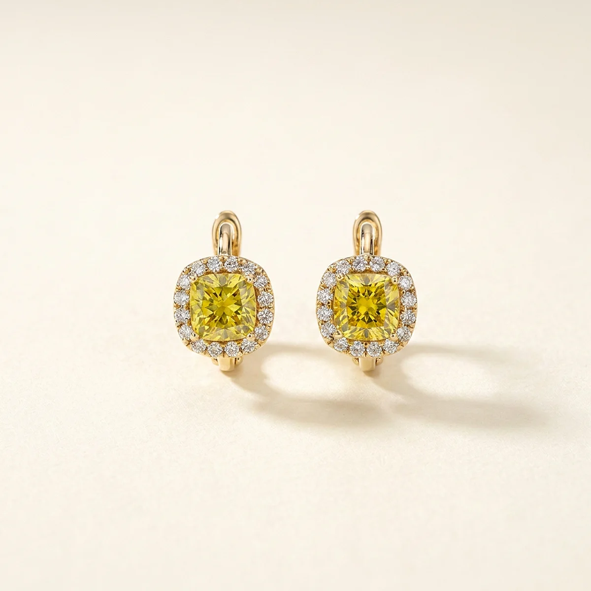 A 2ct yellow cushion diamond on yellow gold earrings, custom-designed by Eterneva to honor the remarkable Schuey.