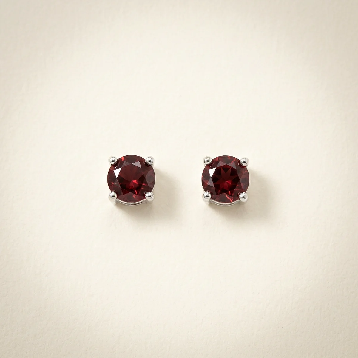 A .25ct red round diamond on white gold earrings, custom-designed by Eterneva to honor the remarkable Dale.