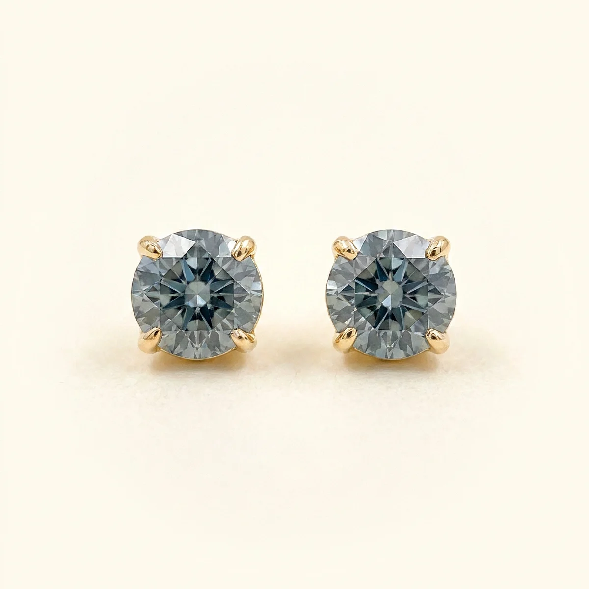 A .4ct blue round diamond on yellow gold earrings, custom-designed by Eterneva to honor the remarkable Erica.
