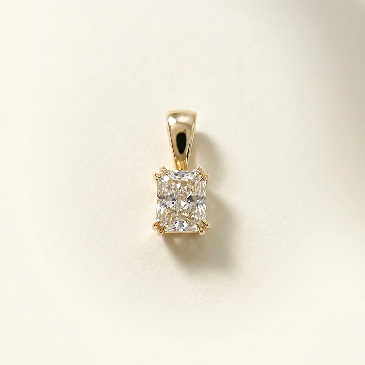 A .25ct colorless rectangular radiant diamond on a yellow gold pendant, custom-designed by Eterneva to honor the remarkable Abi.