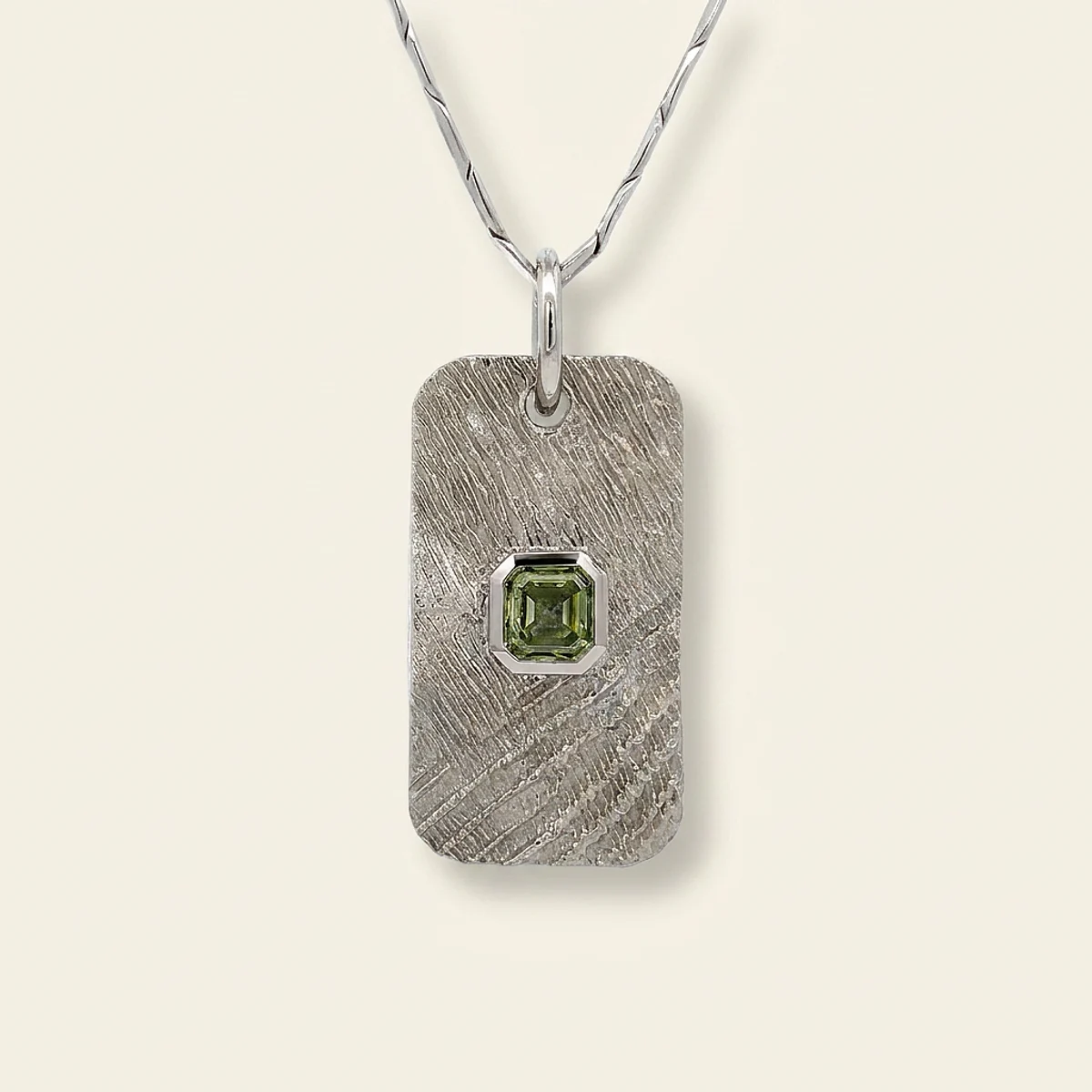 A .5ct green asscher diamond on a platinum pendant, custom-designed by Eterneva to honor the remarkable Nadine.