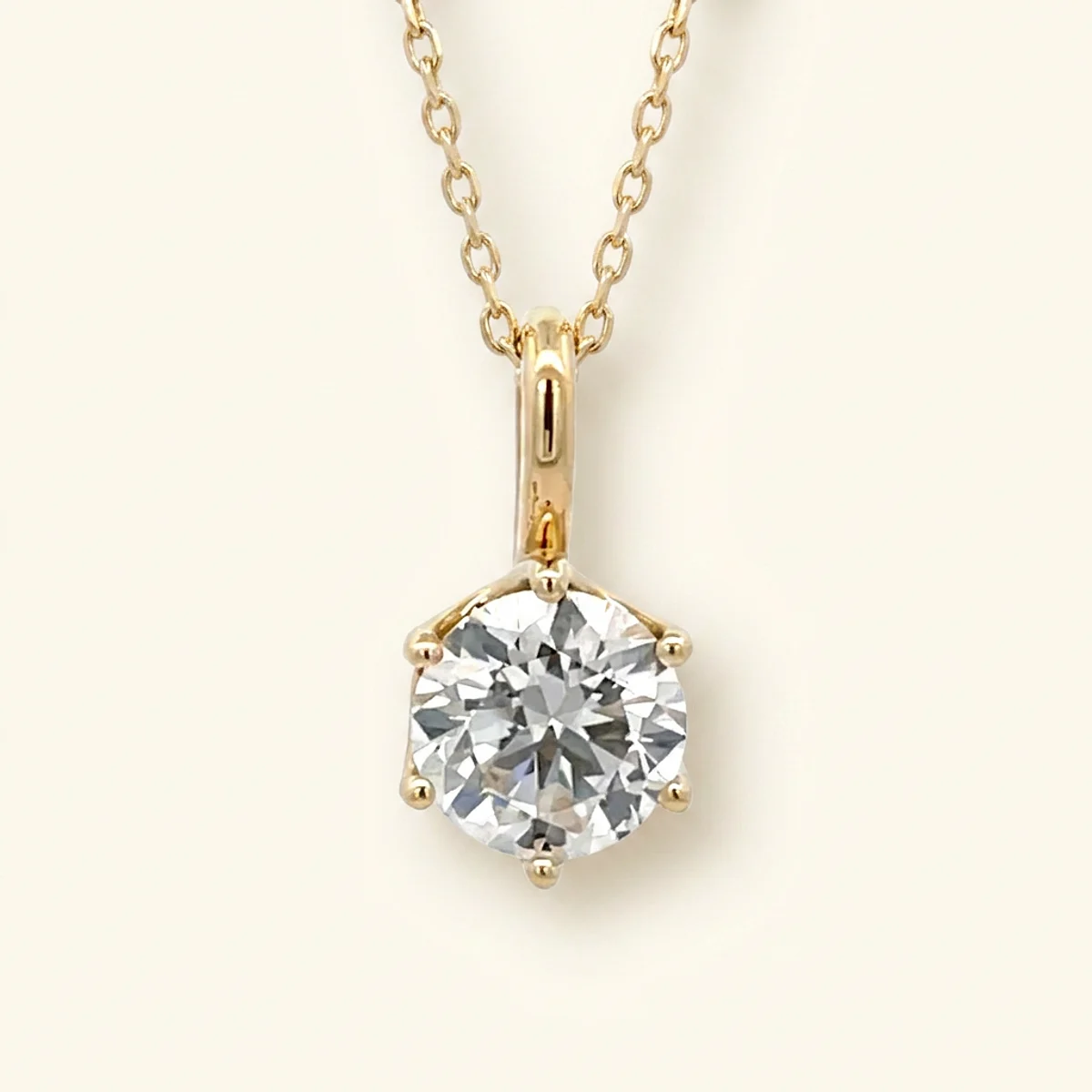 A 1ct colorless round diamond on a yellow gold pendant, custom-designed by Eterneva to honor the remarkable John.