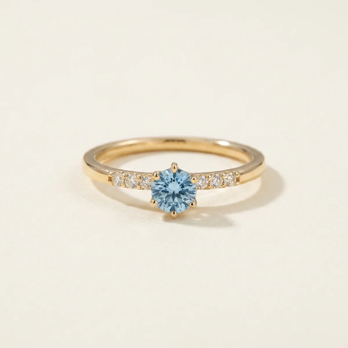 A .25ct blue round diamond on a yellow gold ring, custom-designed by Eterneva to honor the remarkable Dolly.