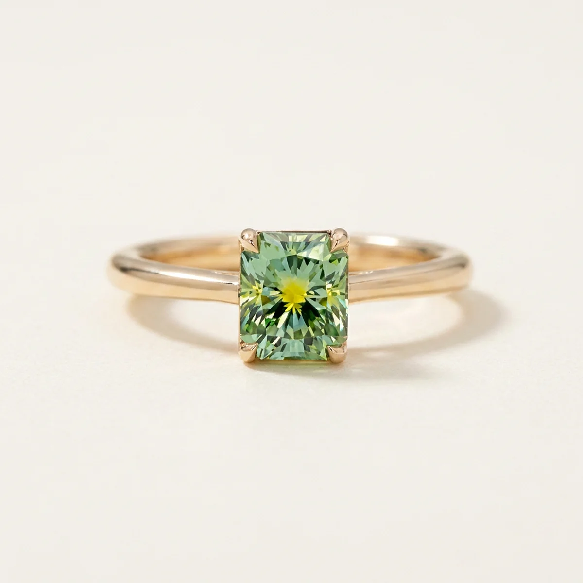 A .75ct green rectangular radiant diamond on a yellow gold ring, custom-designed by Eterneva to honor the remarkable Dina.