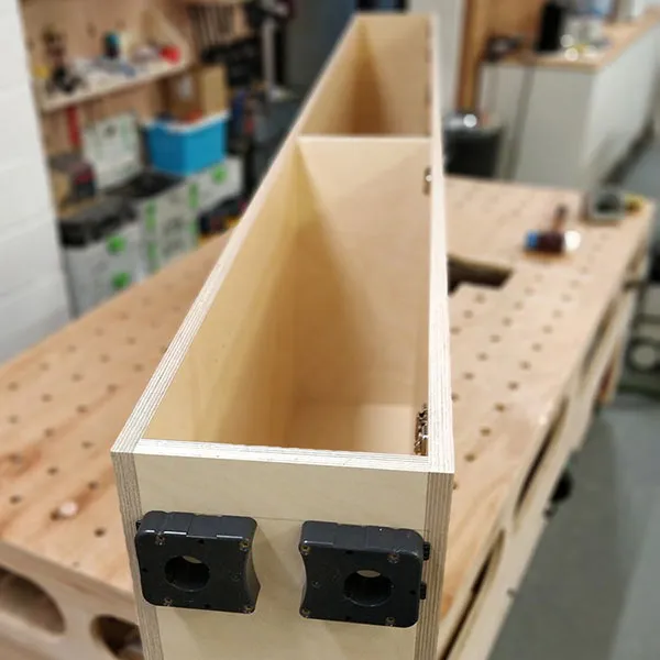 Plywood kitchen cabinet being assembled on workshop bench