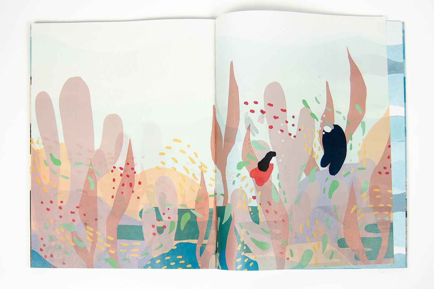 open book spread featuring an illustration of two characters swimming amongst underwater elements printed on glassine paper