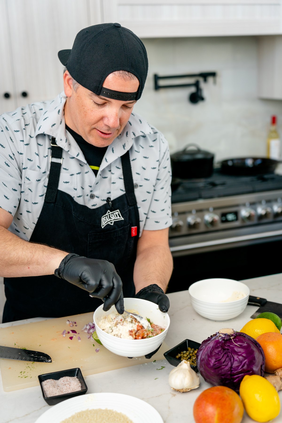 Folding the salmon cake mixture together in a white bowl
