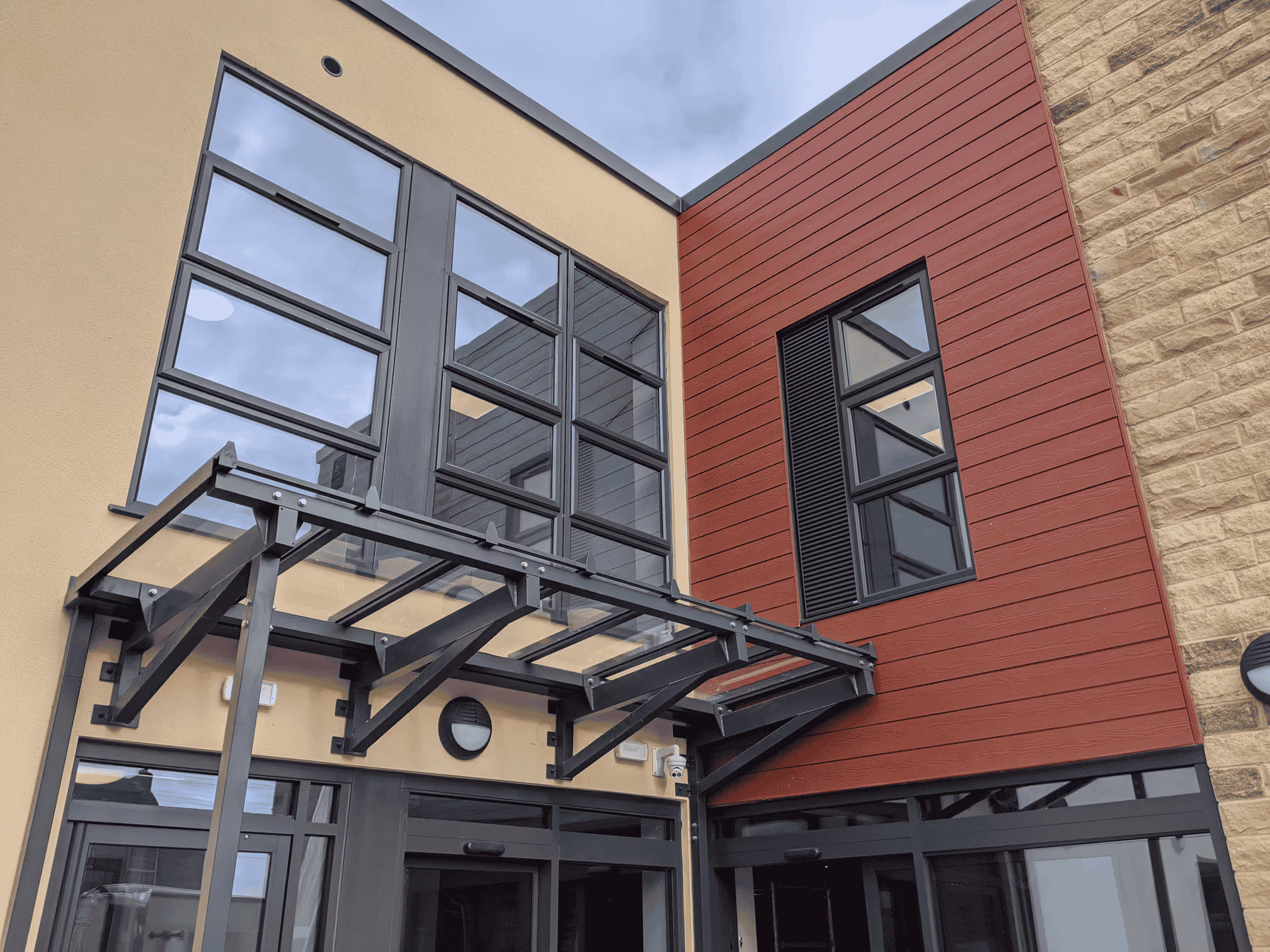 A photo of the front of the Croft Medical Centre building, showing the red cladding and stone.