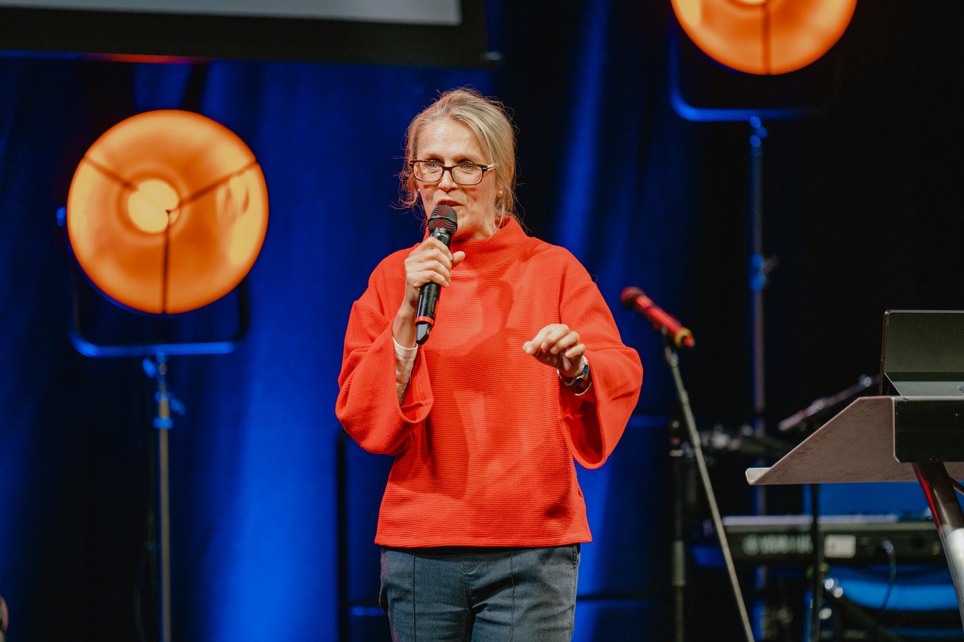 A speaker teaching from the main stage at LAUNCH 2025