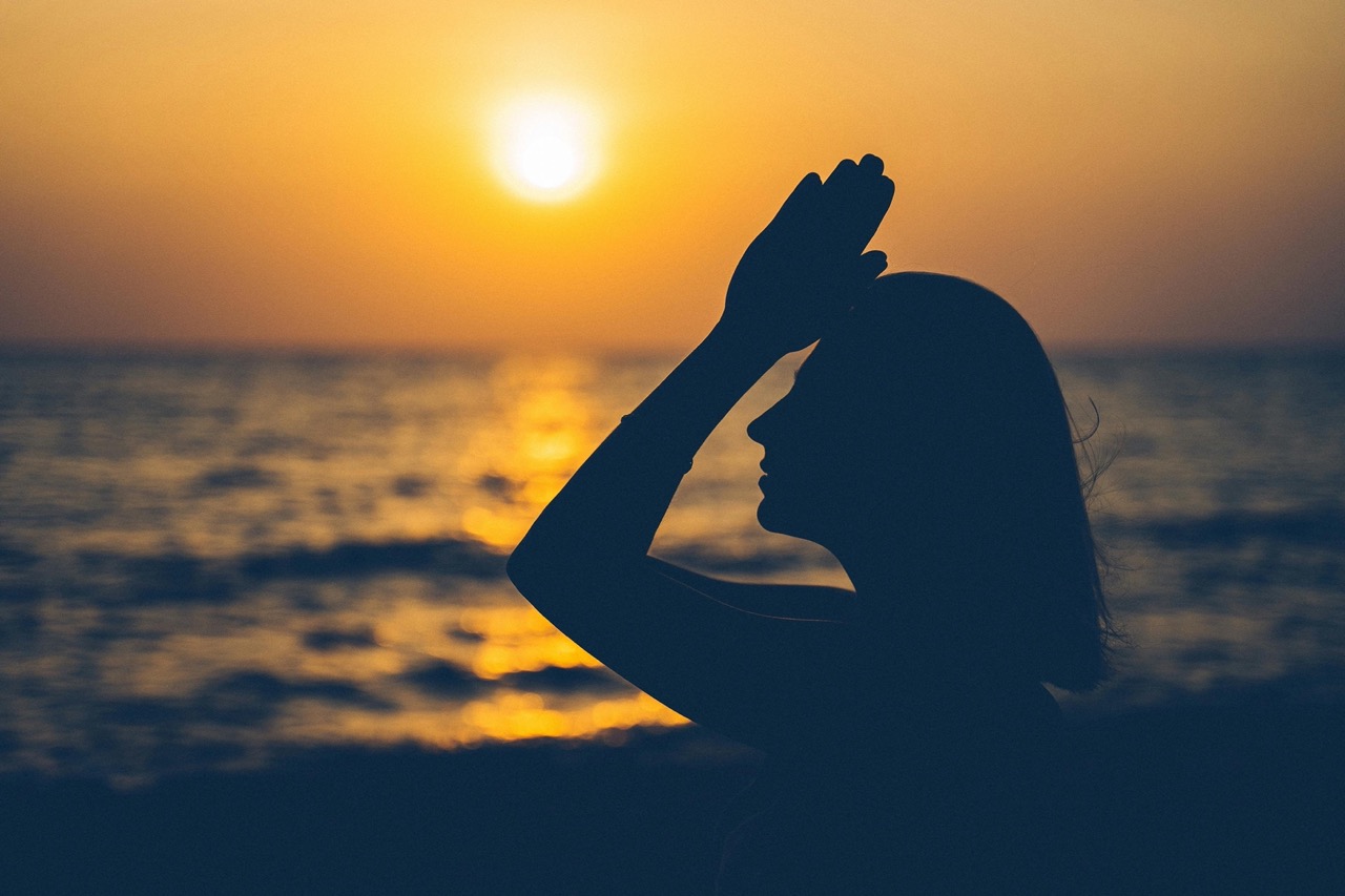 Woman in quiet reflection after an Ayahuasca ceremony at a Behold Retreats healing center