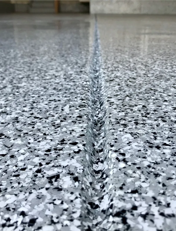 closeup view of gray and black flake floor coating in garage