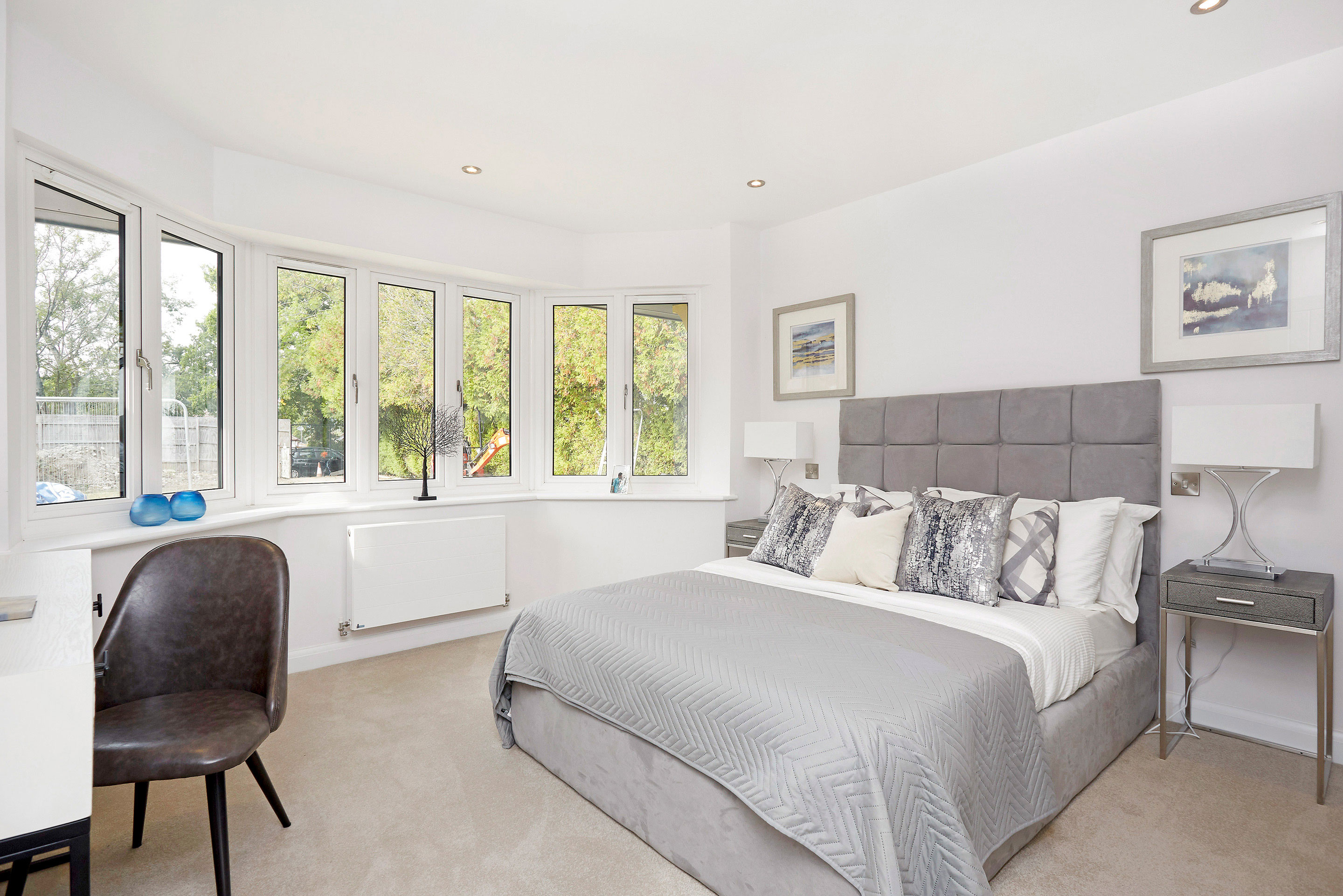 Double bedroom with interior design features, large circular bay windows and dressing table