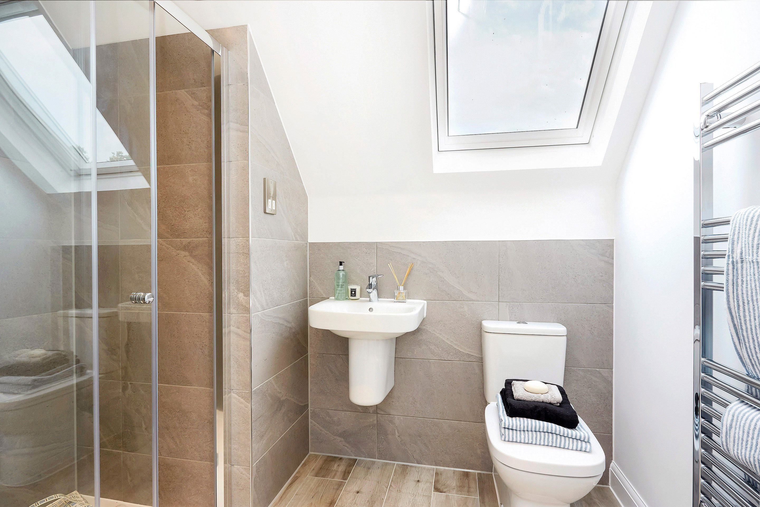 Modern clean shower room with skylight and grey tiles