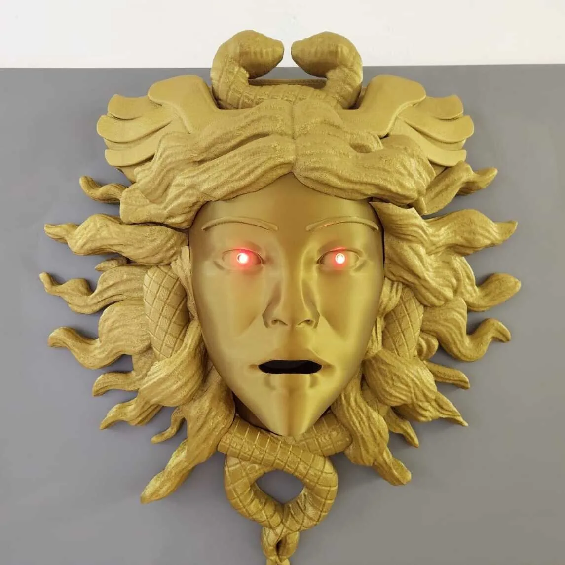 Máscara de Medusa dorada con ojos iluminados impresa en 3D en São Paulo