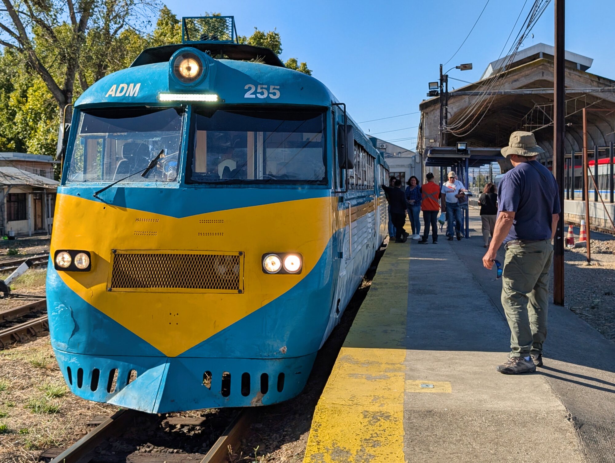 Historic blue and yellow Buscarril railcar ADM-255 waiting at Talca Railway Station for the trip to Constitución.