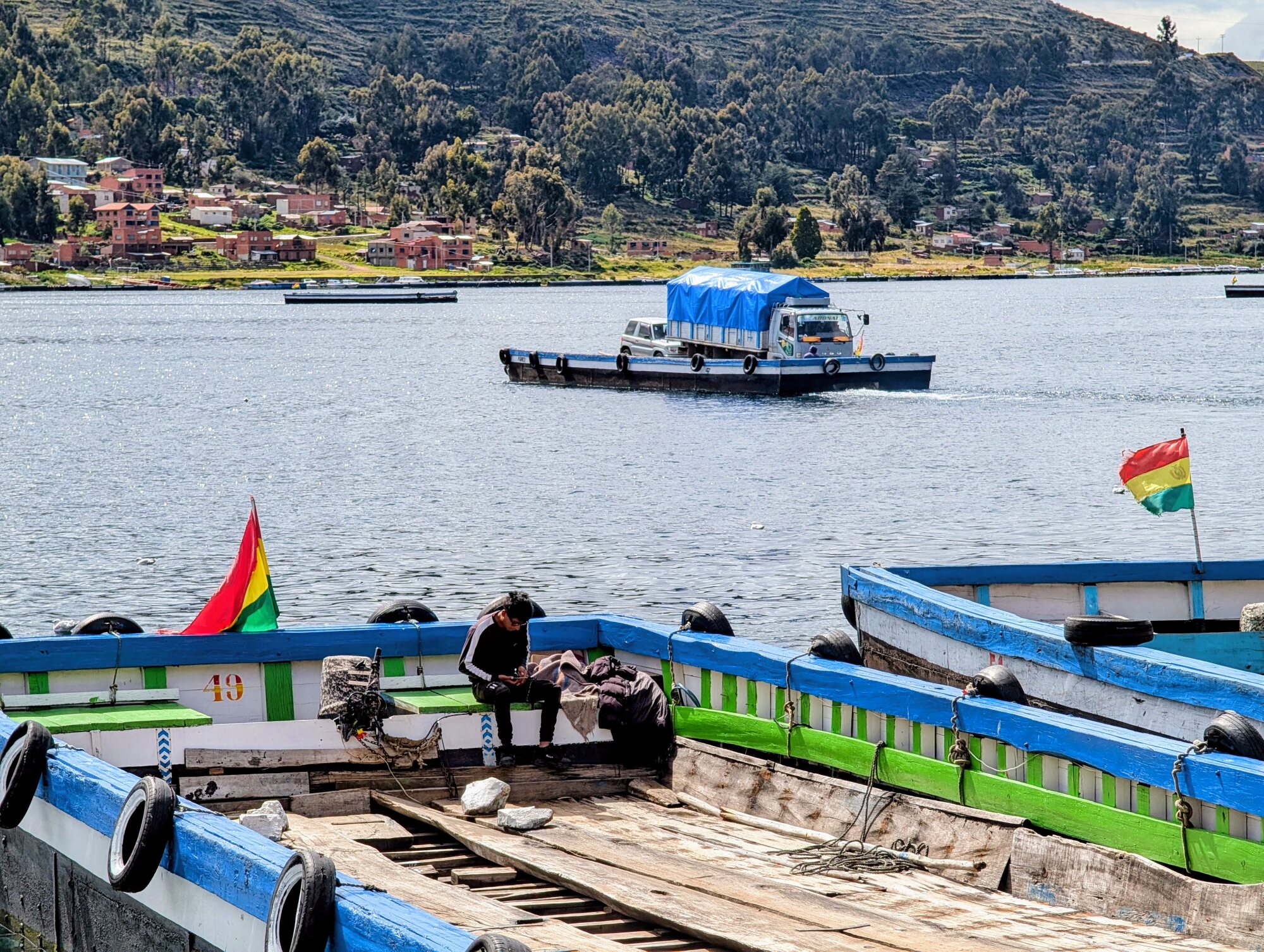 Vehicle ferry carrying a truck and car across the Strait of Tiquina on Lake Titicaca, Bolivia.