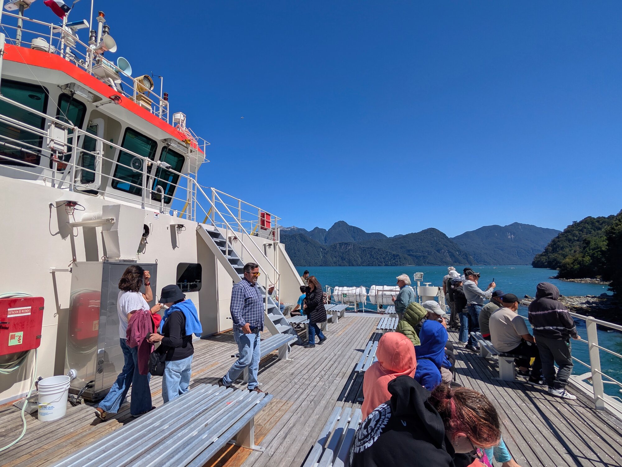 Passengers aboard a ferry crossing a fjord along the Carretera Austral in Chilean Patagonia.