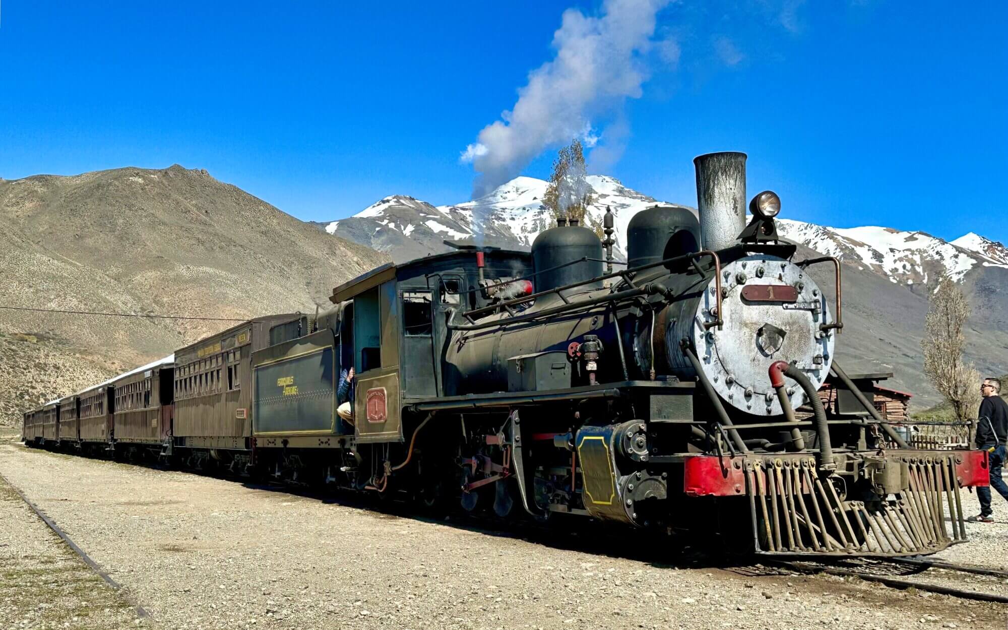 Historic La Trochita steam train with traditional carriages in the mountains of Argentine Patagonia.