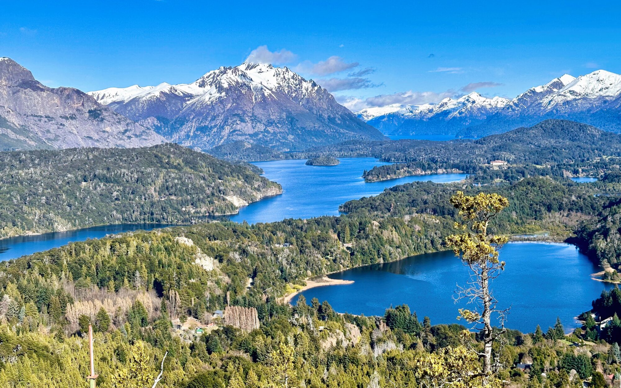 Mountain lakes, forests and snow-covered Andes near Bariloche in Argentine Patagonia.