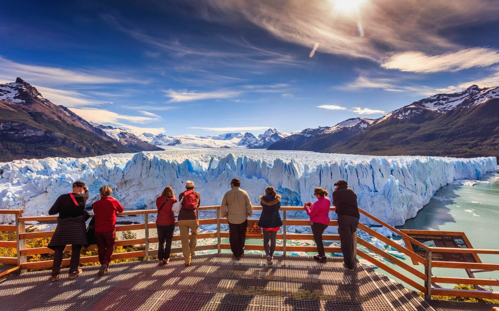 Travelers viewing the towering ice front of Perito Moreno Glacier from the walkways in Argentine Patagonia.