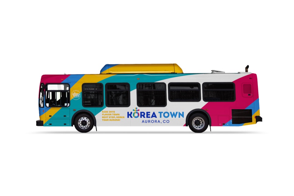 Korea Town Aurora brand applied to a city bus wrap along the Havana corridor