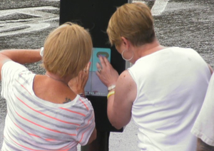 Users furiously tapping to win Street Corner Tug of War