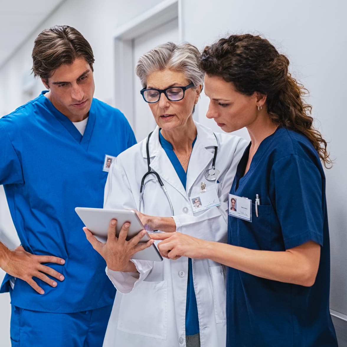 Doctor using a computer and writing down information