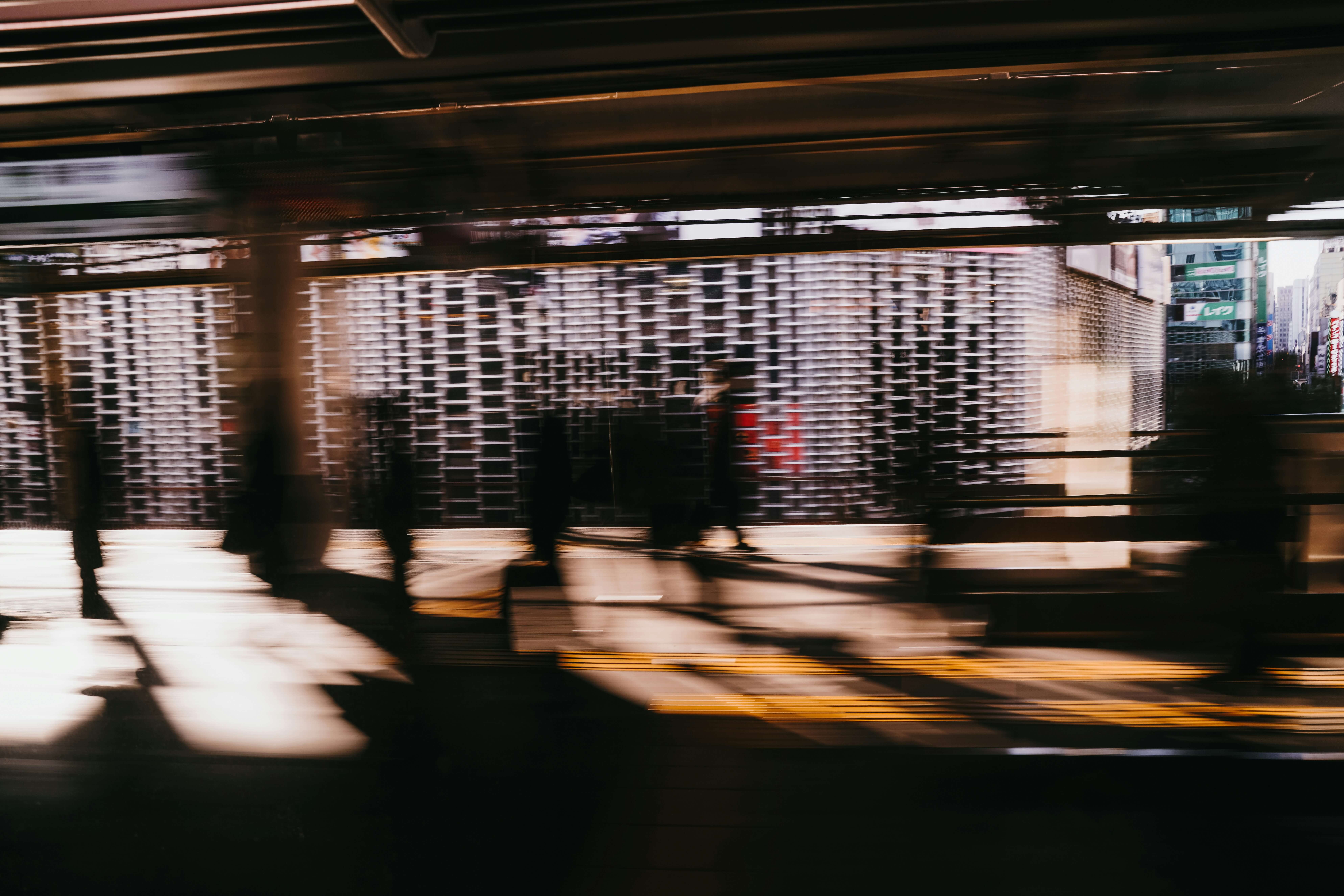Blurred motion of people rushing through a subway station, symbolizing the overwhelming speed and volume of the top cybersecurity vulnerabilities of the 2020s.