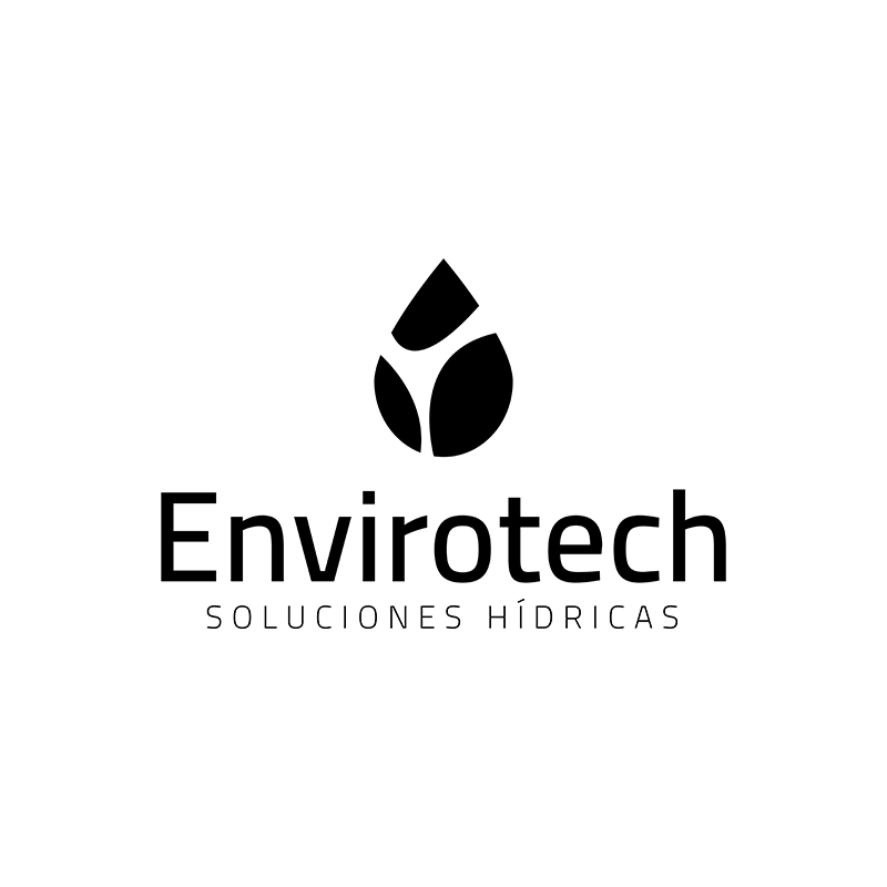 Man wearing glasses working on architectural drawings with wooden scale models on a large desk in a bright studio.