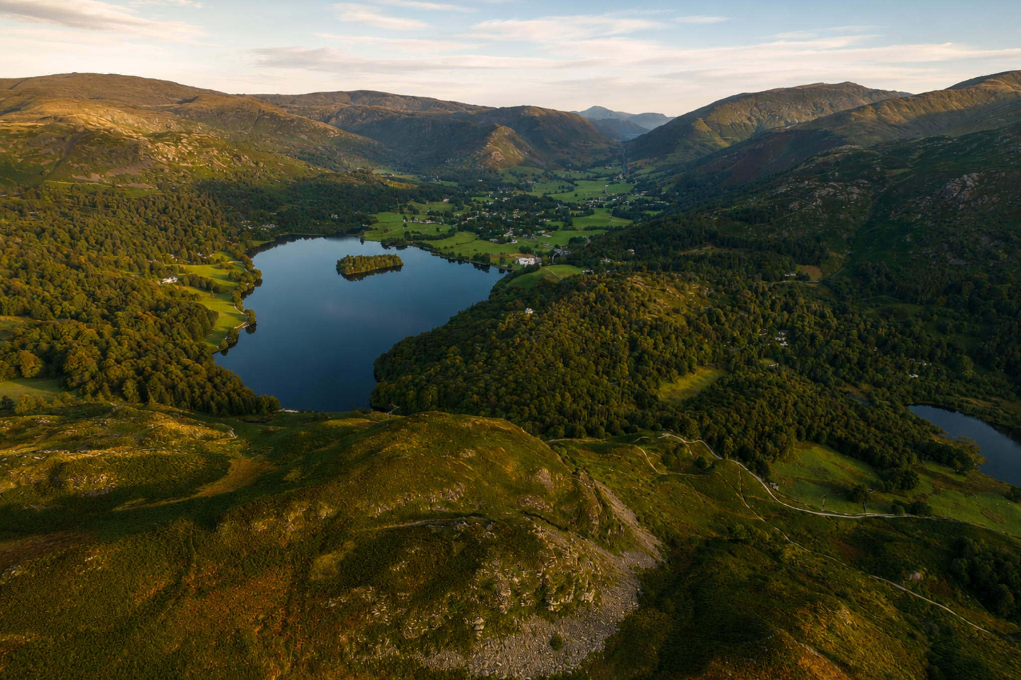 Summit view from Loughrigg Fell across nearby lakes and mountains