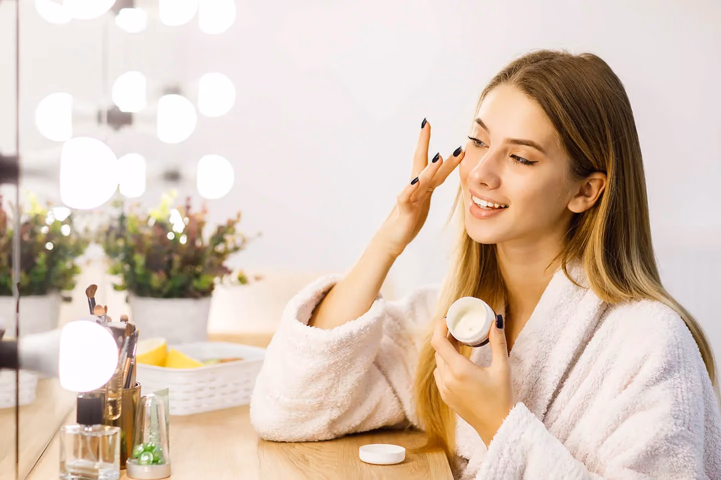 Woman applying face cream for healthy, hydrated skin