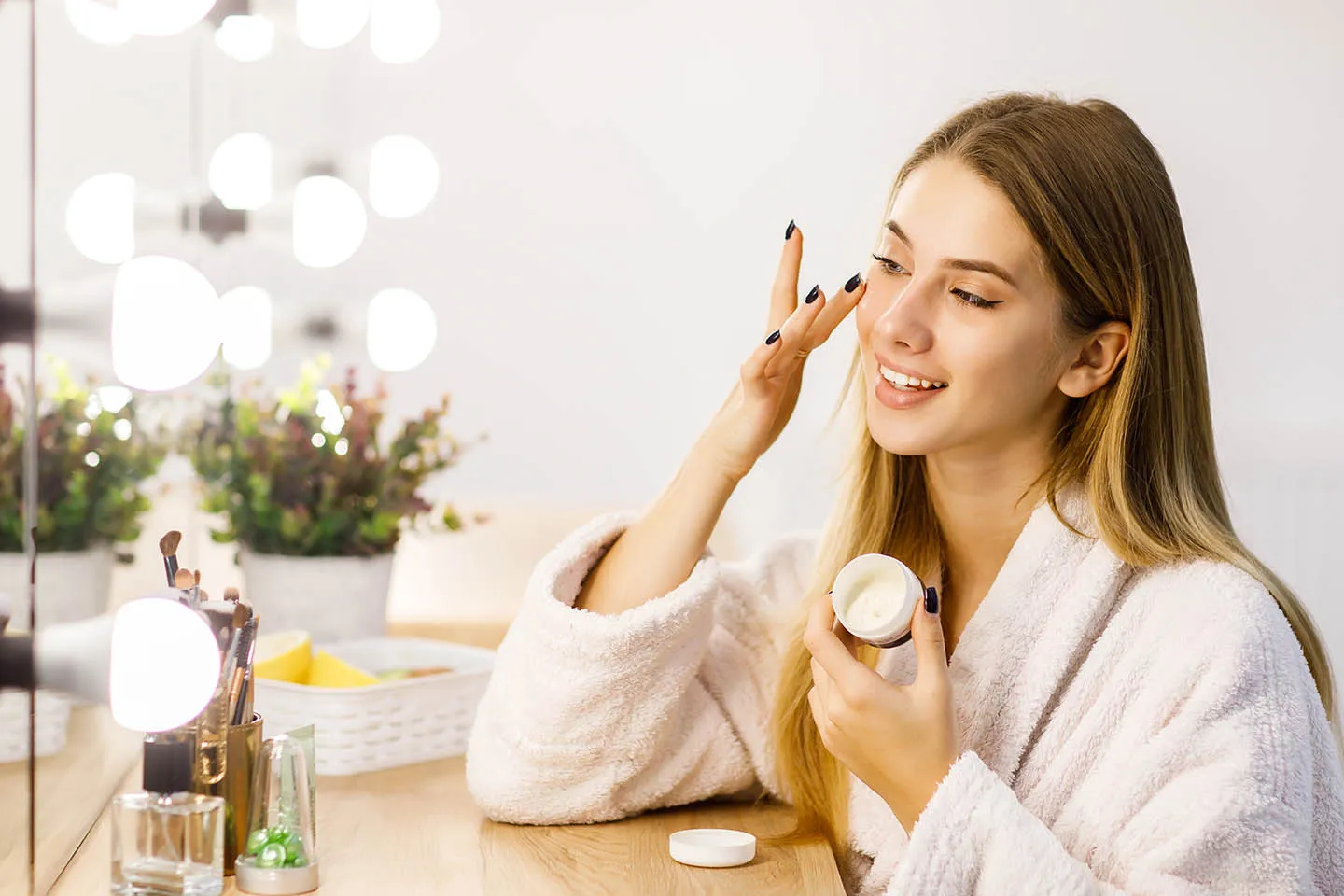 Woman applying face cream for healthy, hydrated skin