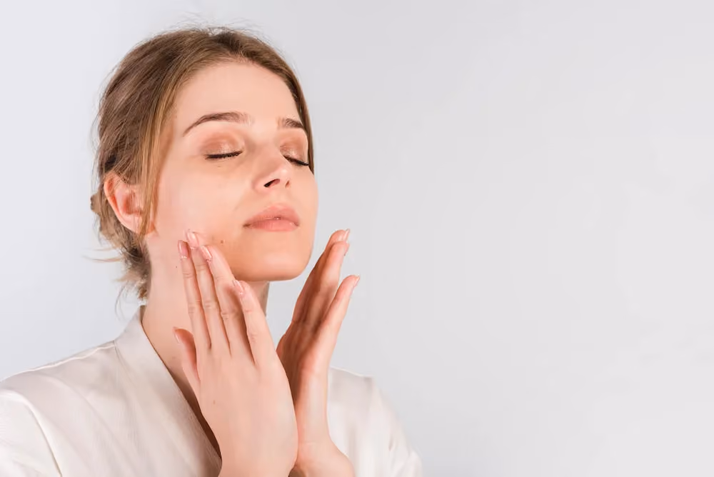 Image of a woman holding her face