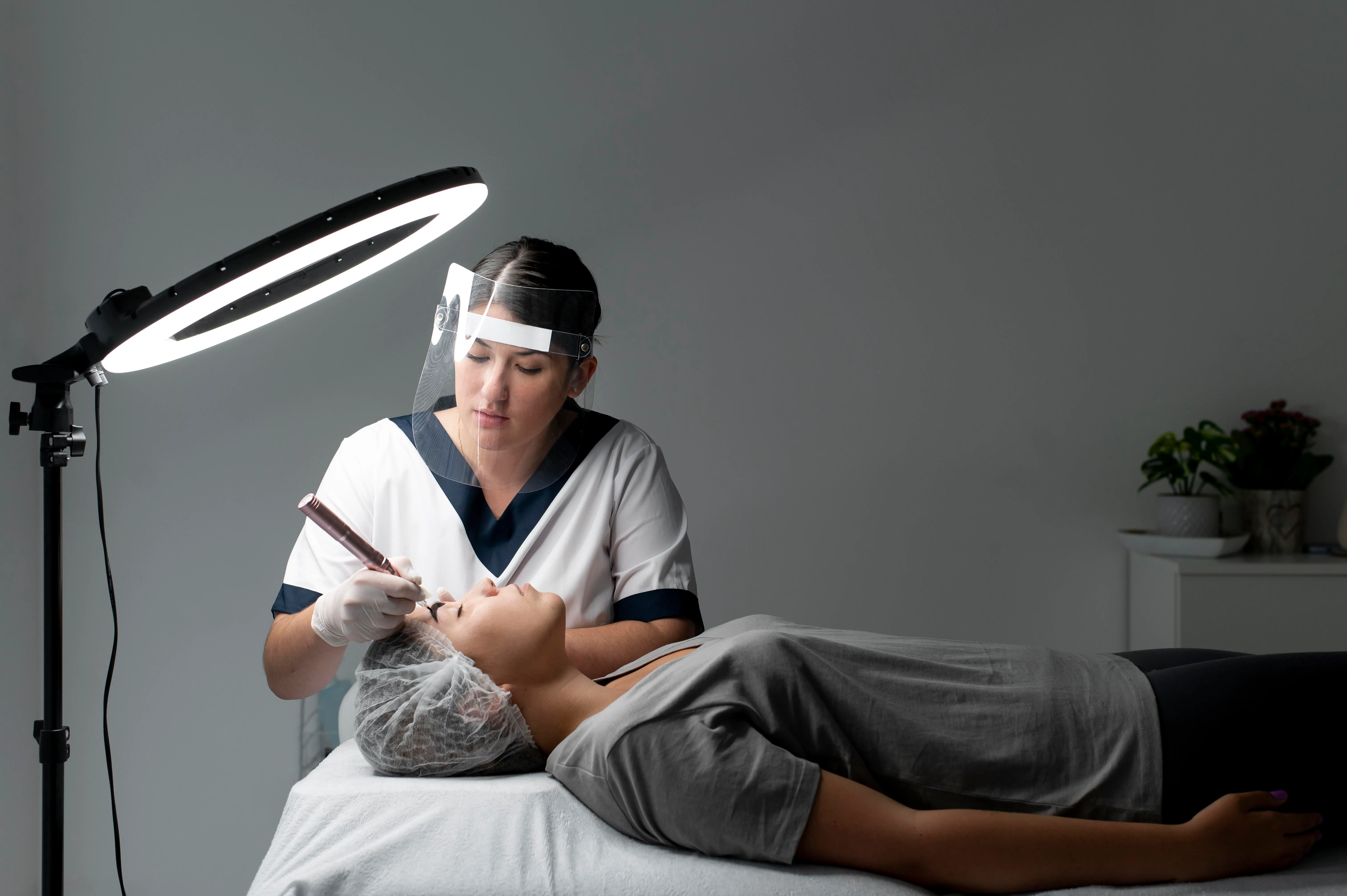 Aesthetic professional providing a non-surgical facial treatment