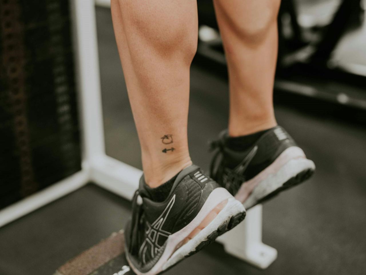 a man doing calf raises at the gym