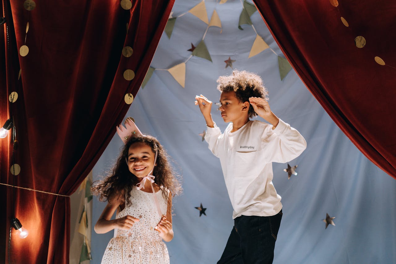 two kids performing a theatre play on a stage
