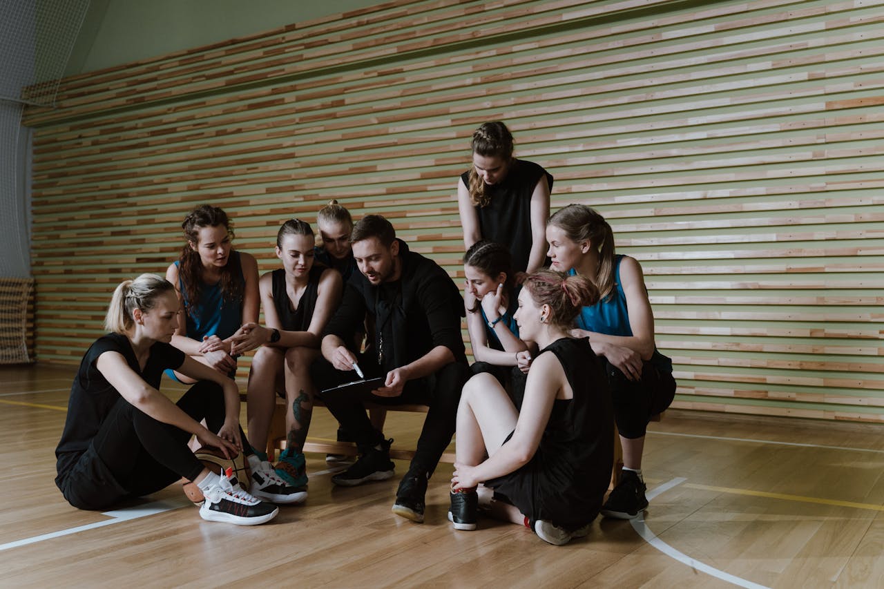 a coach giving his team feedback, on a basketball court