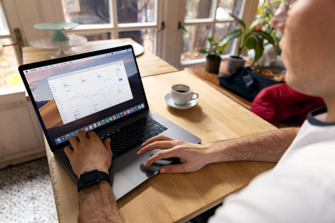 a person viewing a line graph on his laptop