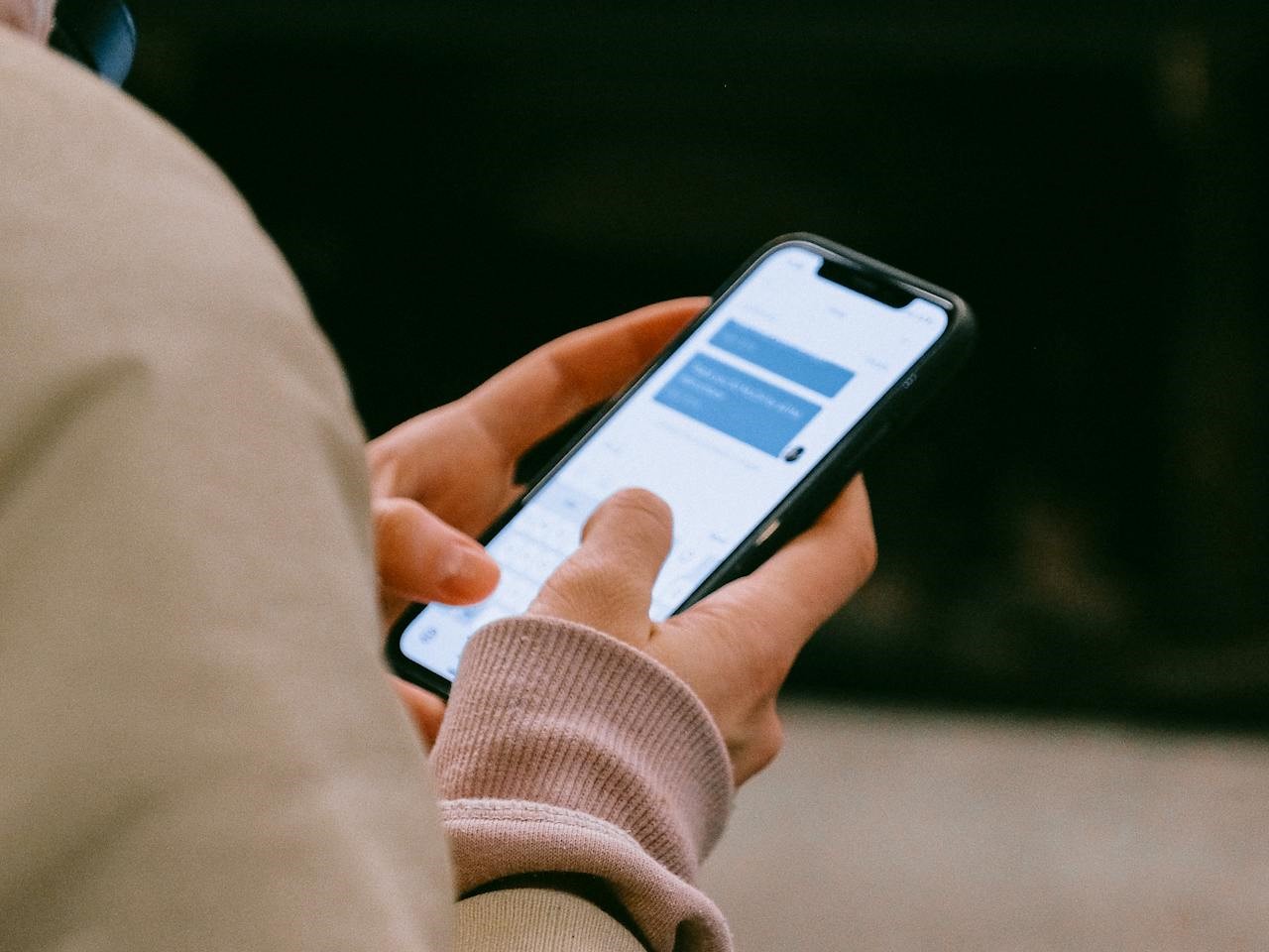 a person checking text messages on their mobile phone