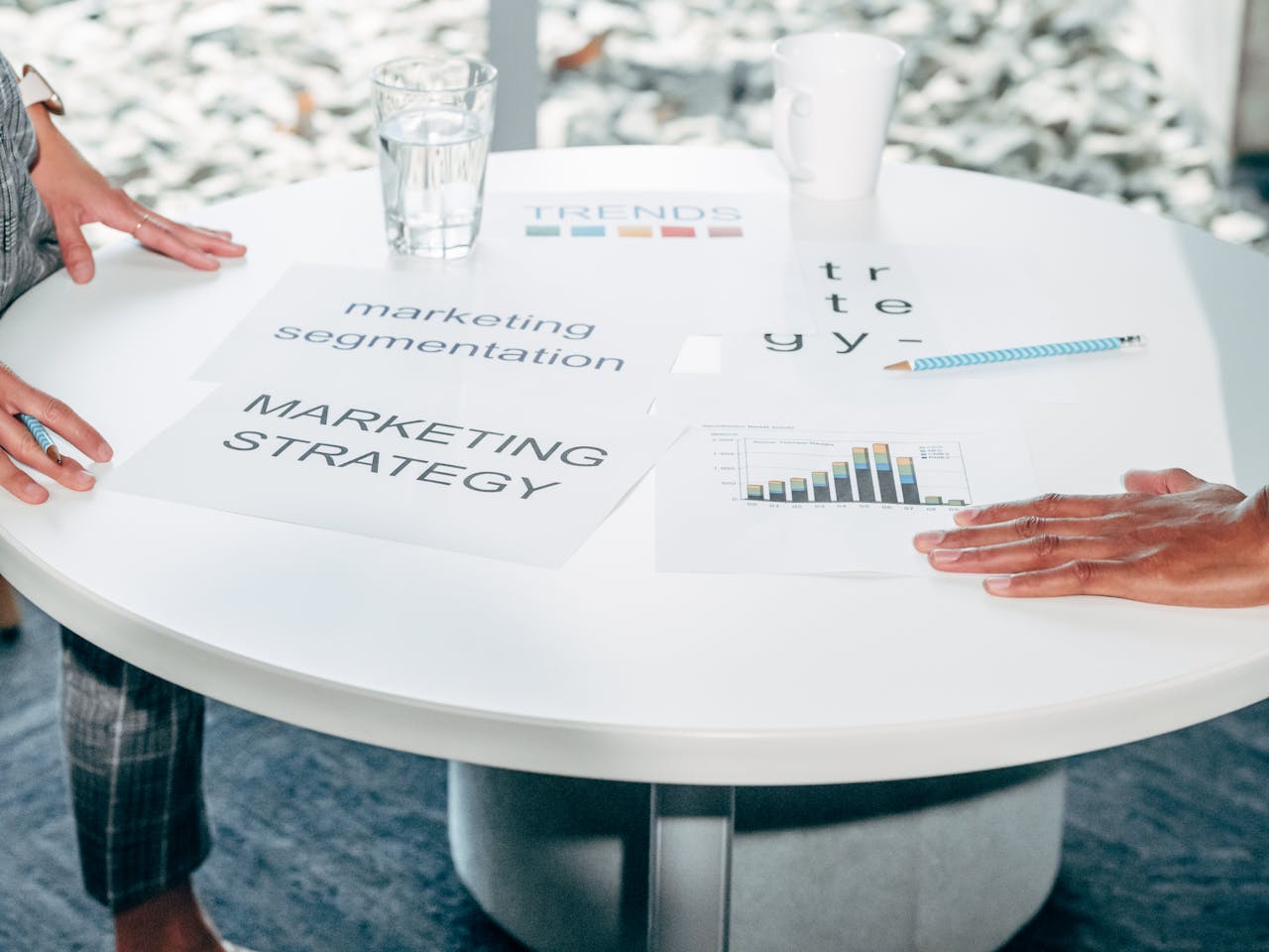 a table with bar graphs and papers with "marketing strategy" and "marketing segmentation" written on them