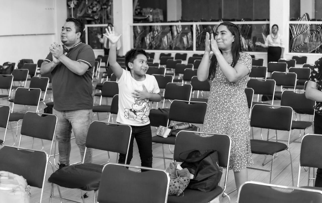 A family joyfully applauding a show or recital