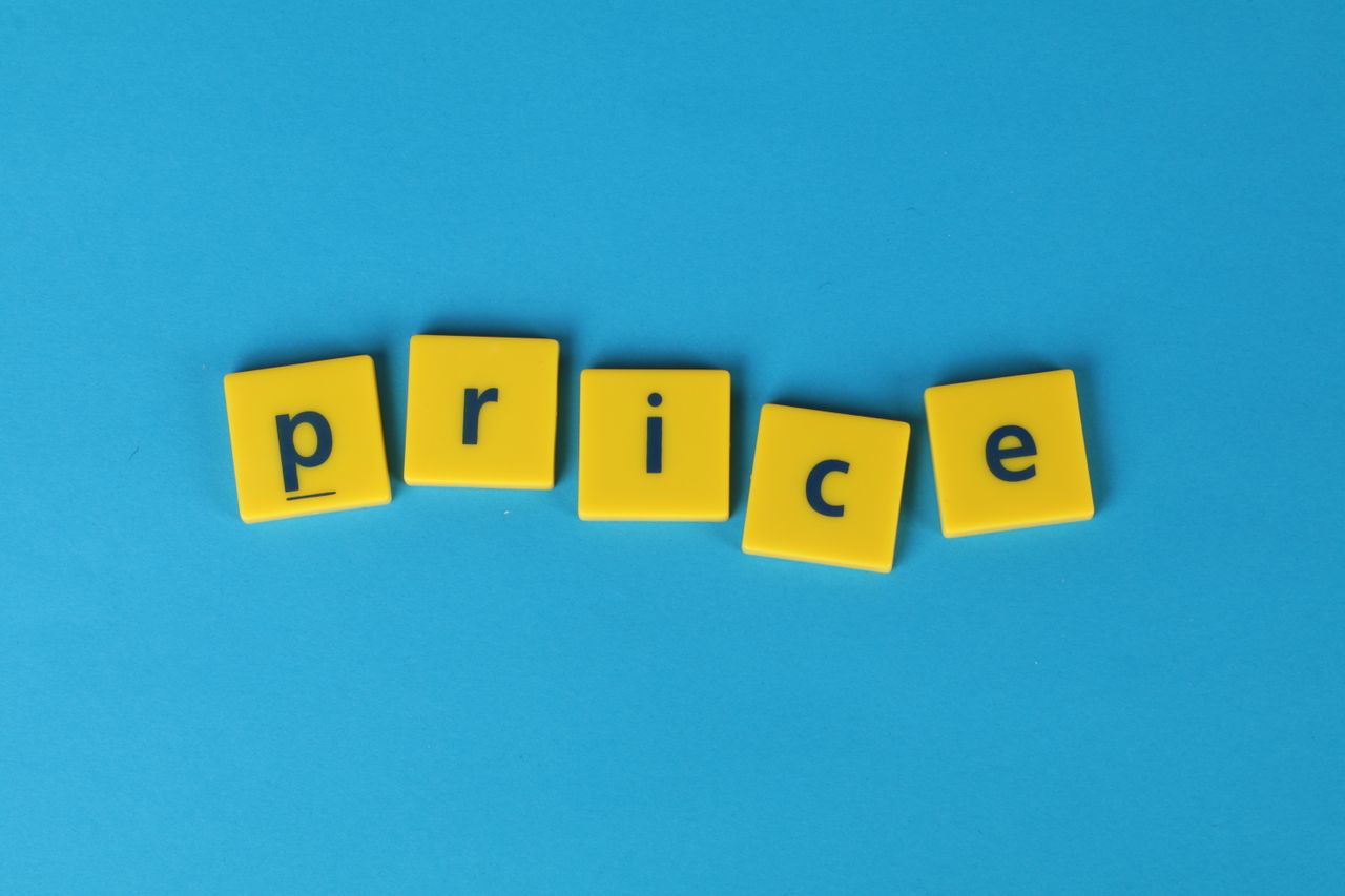 yellow scrabble tiles spelling out 'price' against a blue background