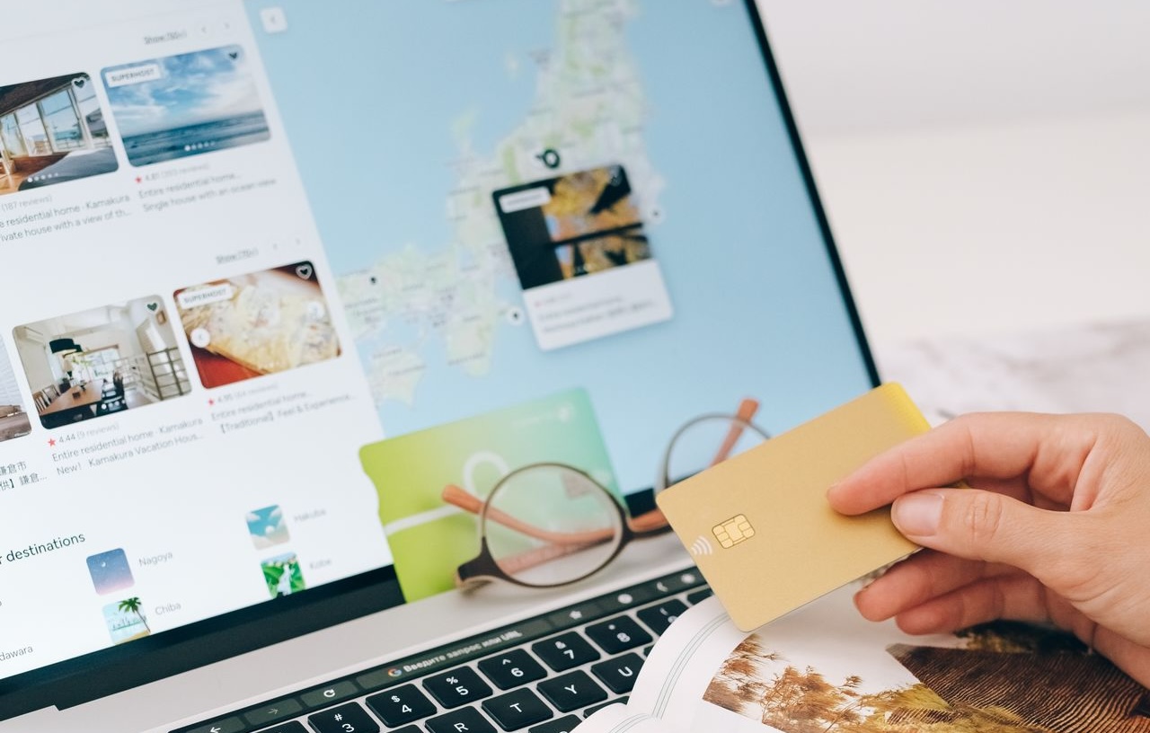 a person making an online booking on their laptop using a credit card