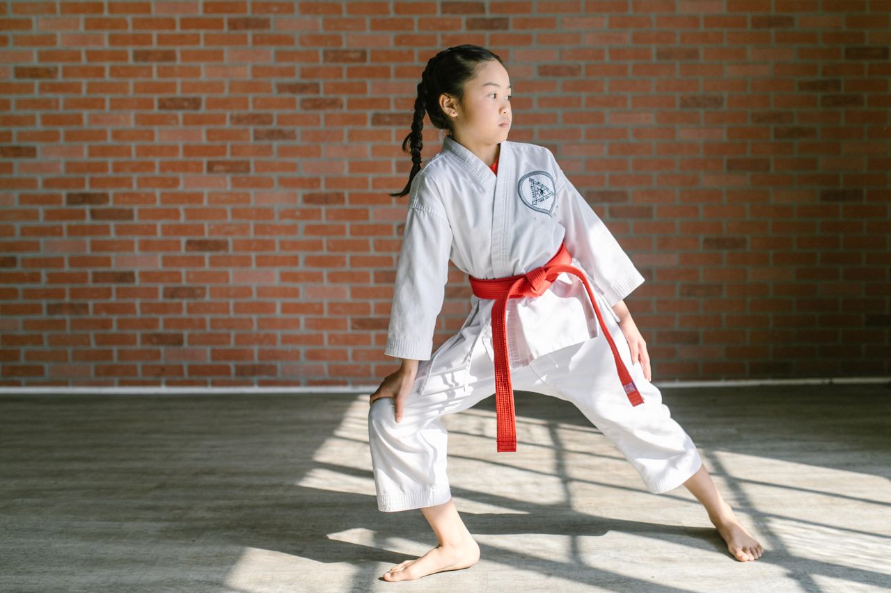 Child practicing in a martial arts school