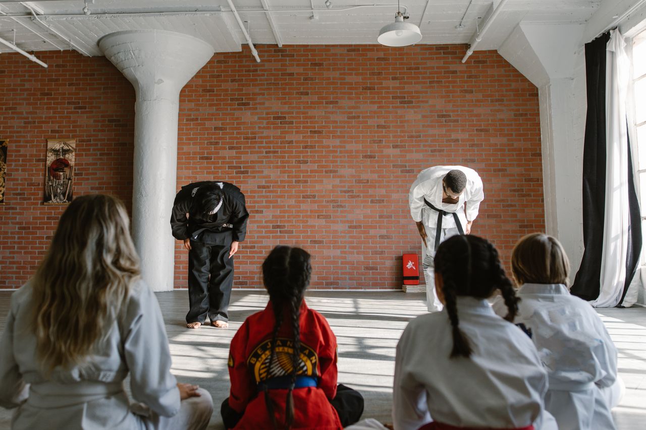 Martial arts school coaches giving demo