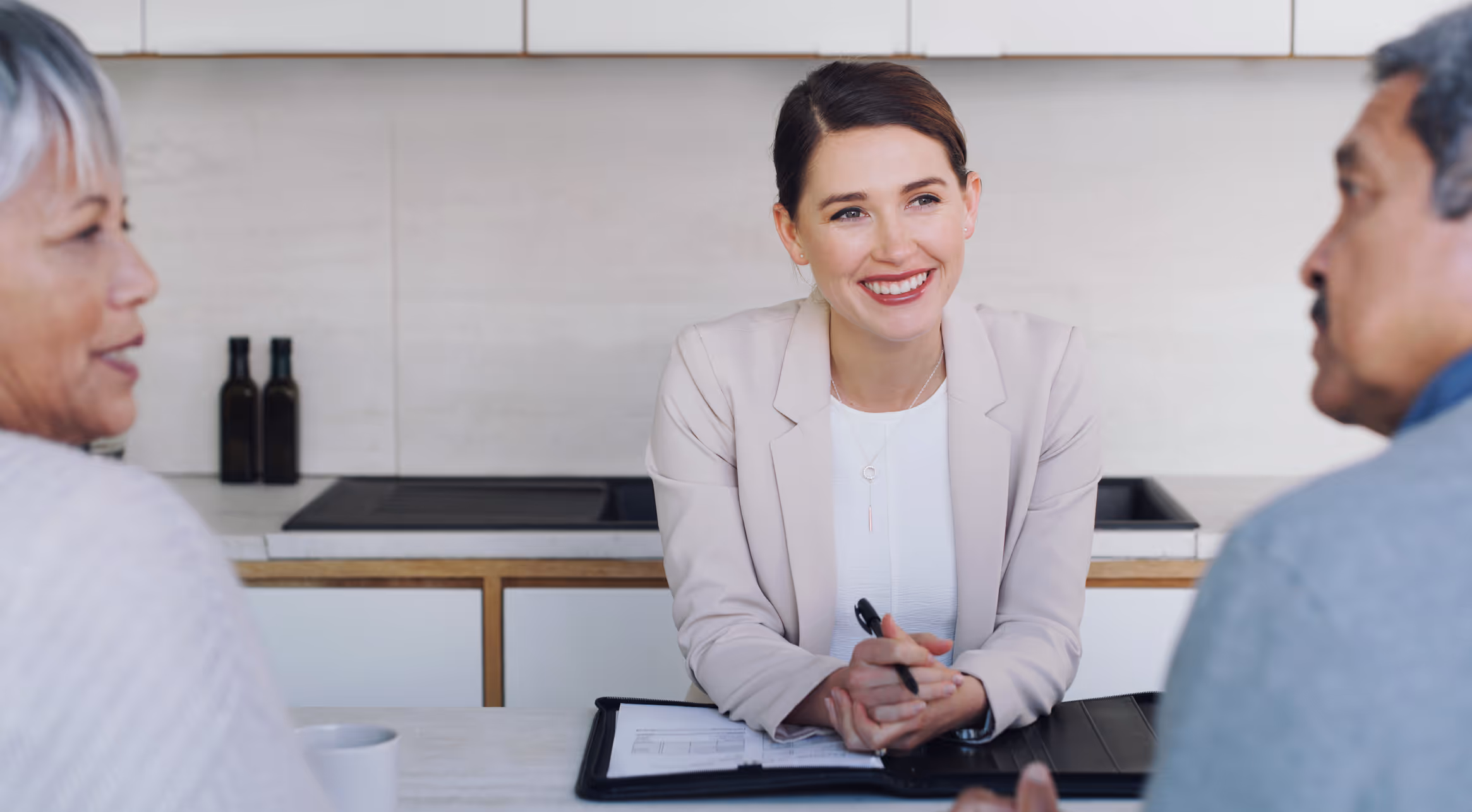 A female lawyer is meeting with her clients showing them a copy of a custody agreement containing a sobriety clause