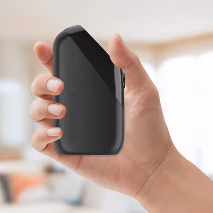 A hand holding a Soberlink device.