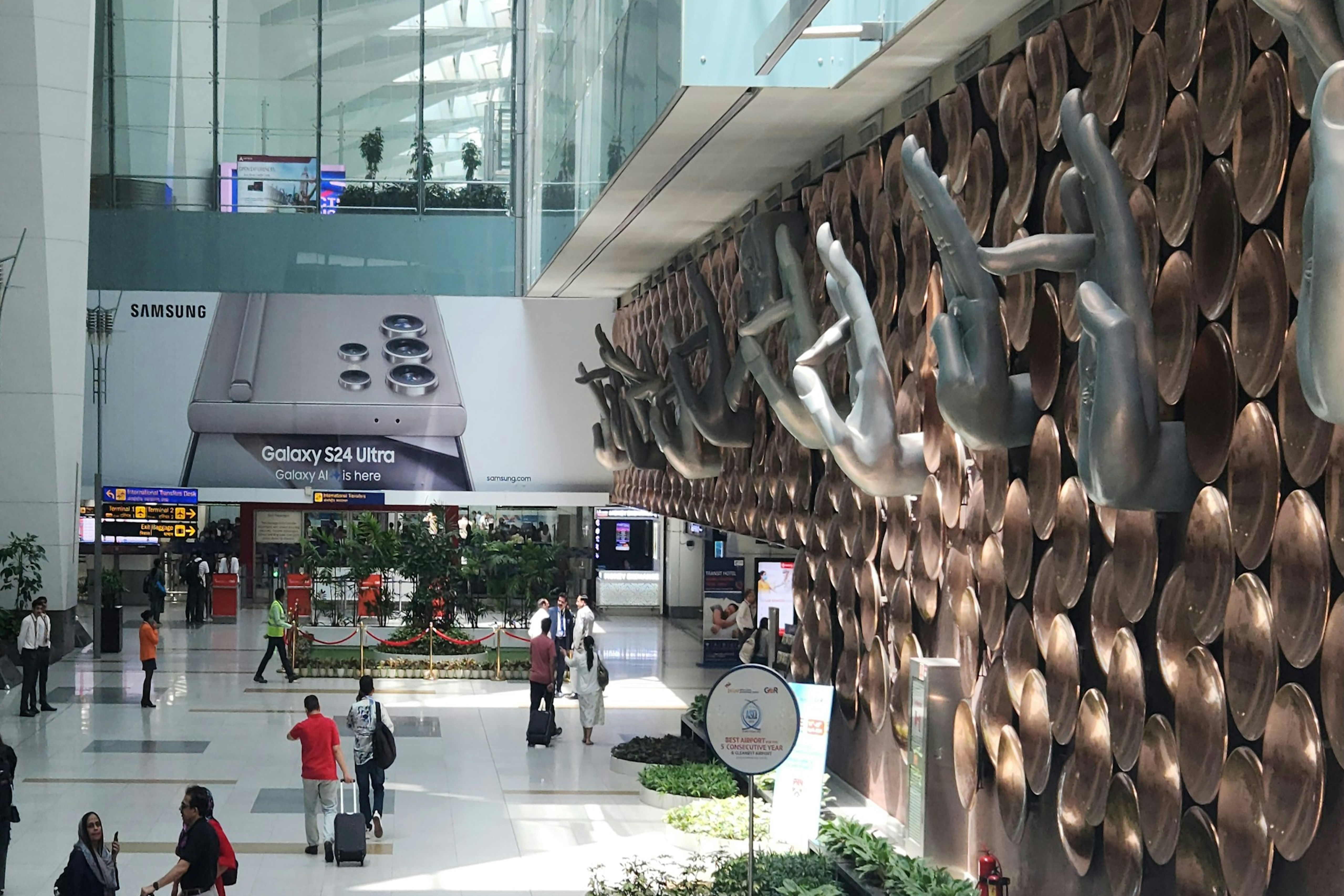 A professional woman is sitting in a seat on an airplane while working on her laptop.