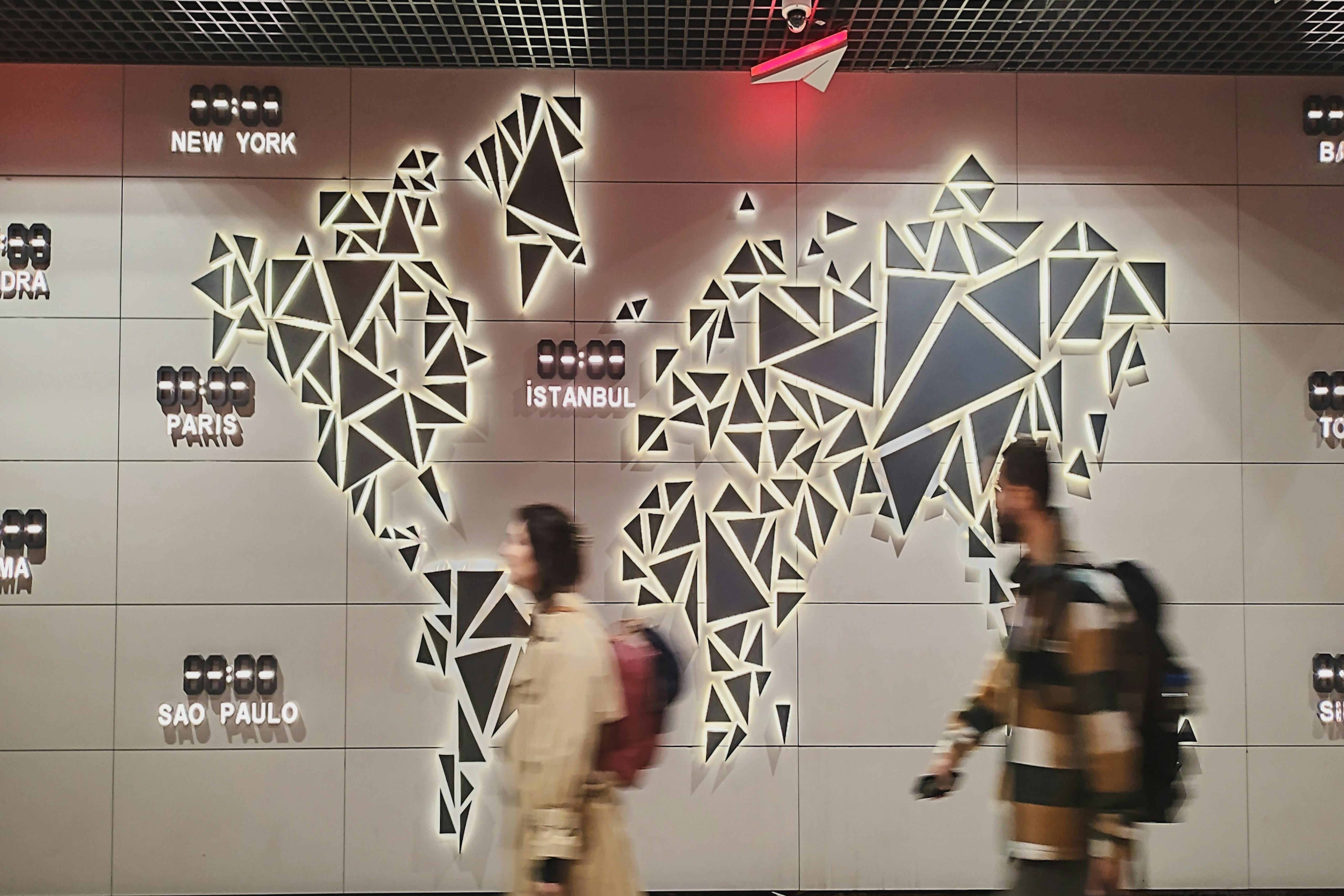 A professional woman is sitting in a seat on an airplane while working on her laptop.